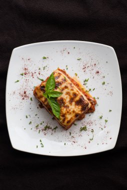 Lazanya bir kare beyaz tabakta