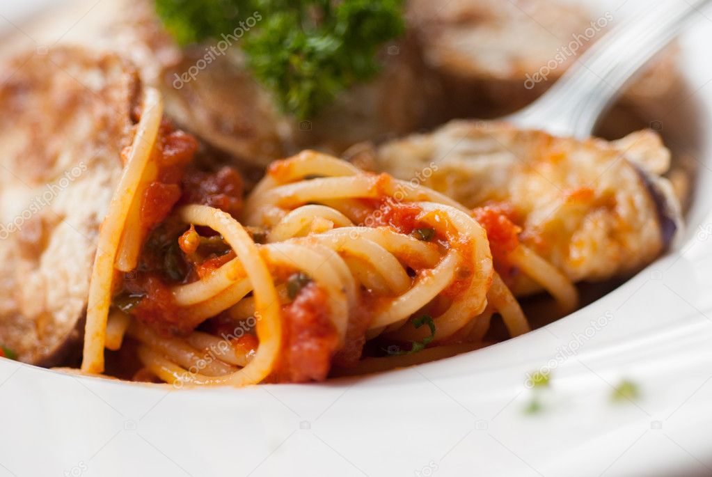 Spaghetti with a slice of grilled eggplant