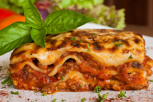 Lasagna on a square white plate