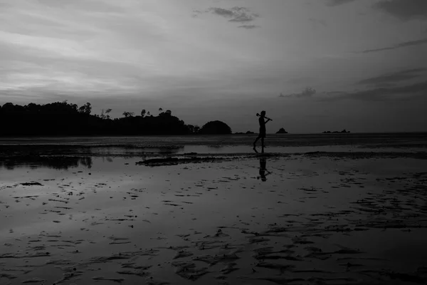 Man on the beach with reflection in water during sunset. — Stock Photo, Image