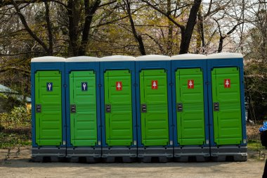 Long row of mobile toilets  clipart