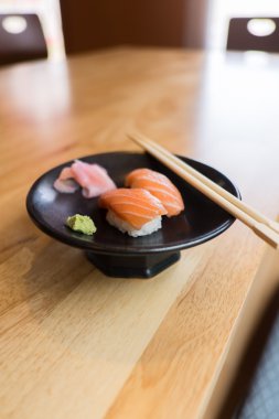 sushi salmon on Black Ceramic Plate