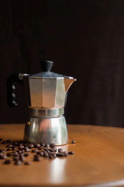 A moka pot and a cup of coffee with roasted coffee beans — Stock Photo, Image