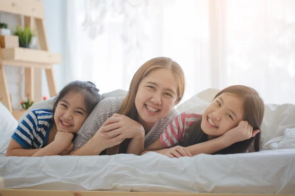 Healthy Asian family smiling and lying on the bed, Happy family — Stock Photo, Image