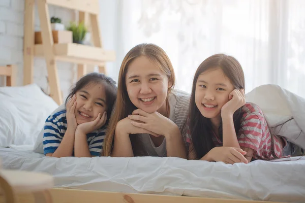 Healthy Asian family smiling and lying on the bed, Happy family — Stock Photo, Image