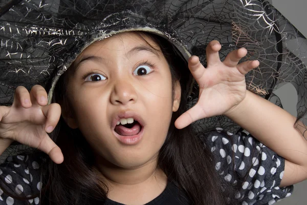 Asian girl in witch hat Stock Picture