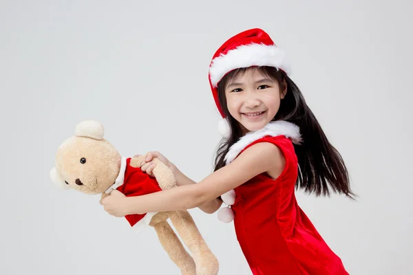 Portrait of little Asian girl in red Santa hat on isolated background — Stock Photo, Image