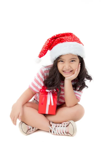 Little Asian girl in Santa hat and red gift box isolated on white — Stock Photo, Image