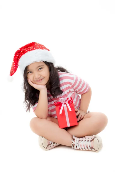 Little Asian girl in Santa hat and red gift box isolated on white — Stock Photo, Image