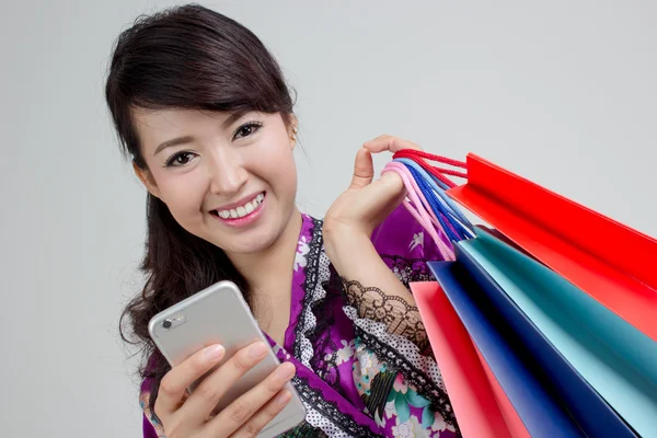 Asian shopping woman with phone Royalty Free Stock Photos