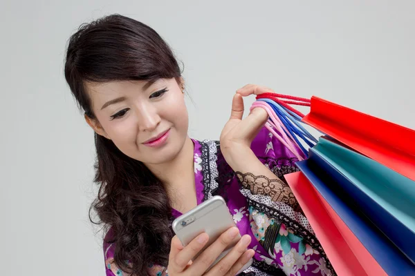 Asian shopping woman with phone Stock Photo