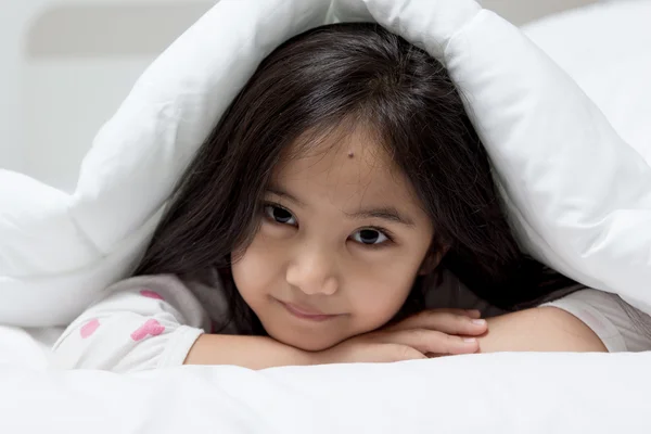 Lovely Asian girl laying on bed — Stock Photo, Image