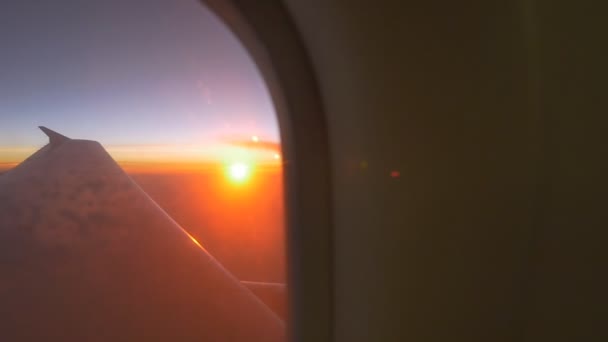 Airplane window view at sunset, Pan shot — Stock Video