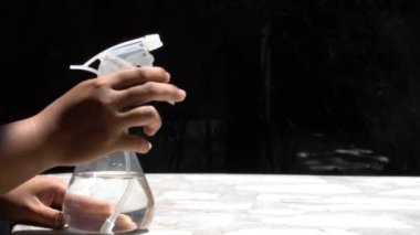 Püskürtme şişesi kullanma ve yüksek hızlı kamera ile siyah arka plan çekim temizleme 120 Fps.