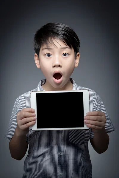 Asian Surprise boy with tablet computer in hand — Stock Photo, Image