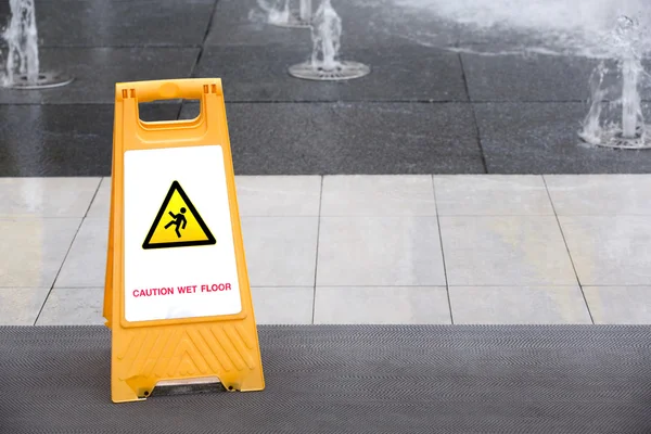 Sign showing warning of caution wet floor — Stock Photo, Image