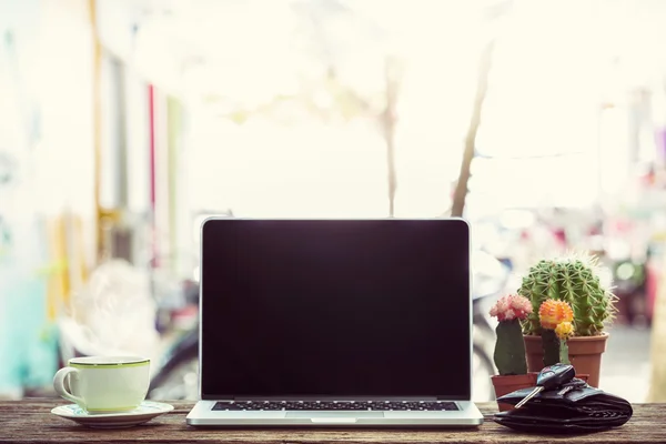 Laptop on wooden table with cup of coffee — Stock Photo, Image