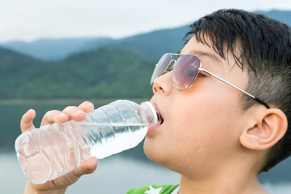 Boy drinking mineral water — Stock Photo, Image