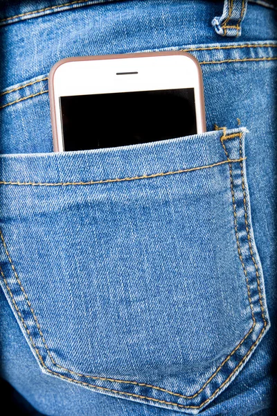 Cell phone in back pocket of girl's jeans — Stock Photo, Image