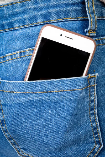 Mobiltelefon i baglomme af pigens jeans - Stock-foto