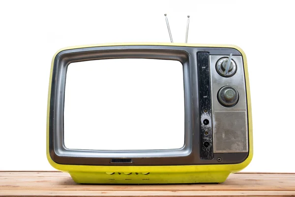 Желтый винтажный телевизор на деревянном столе — стоковое фото
