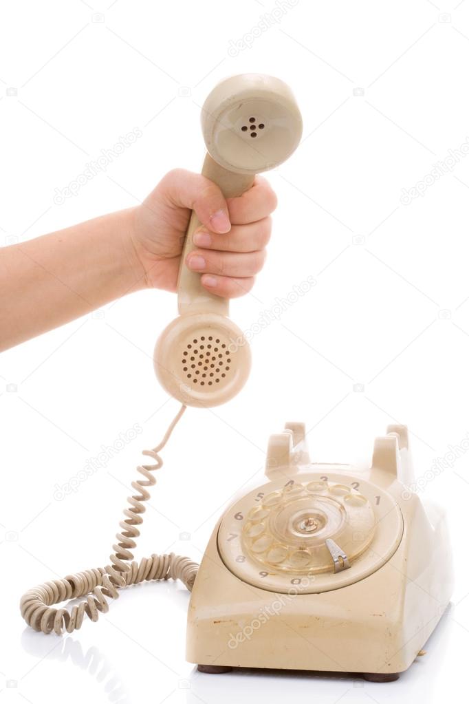 Hand hold vintage telephone cream color 