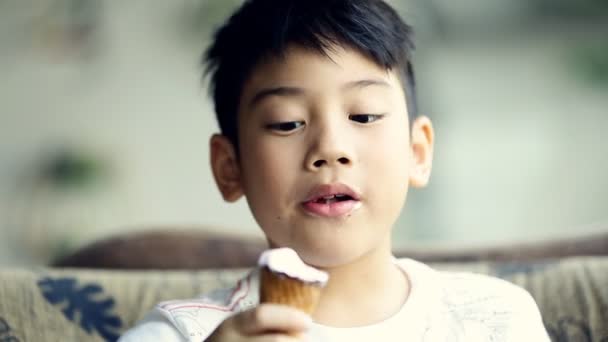 Little asian cute boy enjoy eating an ice cream — Stock Video