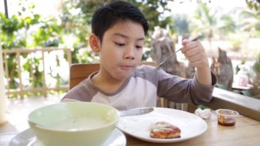 Küçük Asyalı çocuk evde yemek