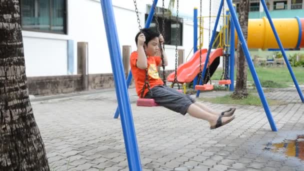 Asian cute boy playing in the park — Stock Video