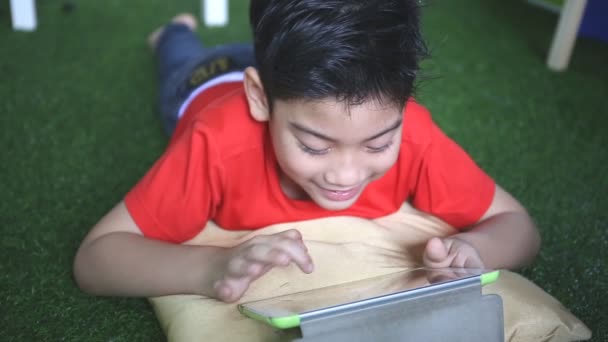 Ungt asiatiskt barn som använder en digital surfplatta tillsammans . — Stockvideo