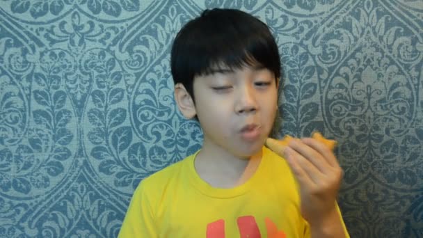 Little Asian child eating donut sweet food — Stock Video