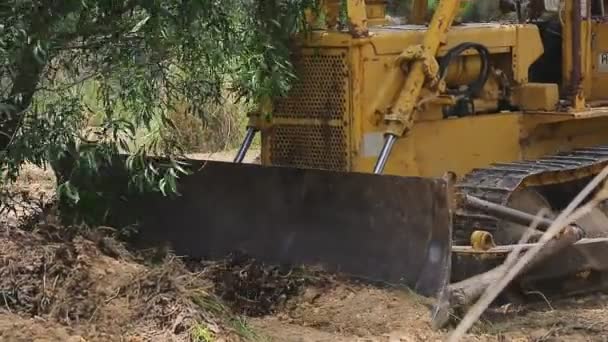 Unbekannte steuern Planierraupe auf Baggergreifer beim Entfernen des Bodens — Stockvideo