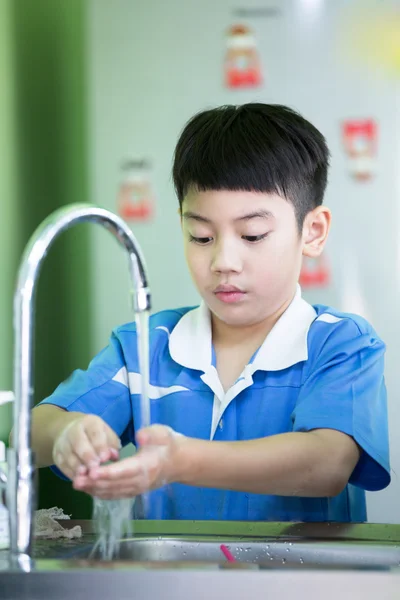 Little asian boy washing his hands in the kitchen room — Stock Fotó