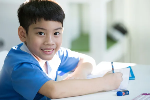 Young asian boy doing his homework — Stock Photo, Image