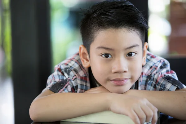 Azjatycki chłopiec jest mały uśmiech i patrząc aparatu — Zdjęcie stockowe