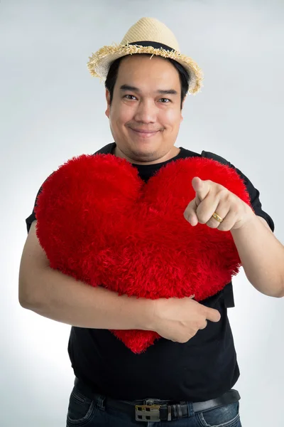 Happy asian man hold big red heart — Stockfoto