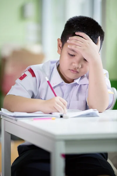 Asian boy be bored doing his homework — Stock Photo, Image