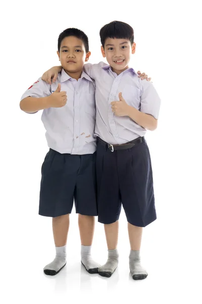 Aziatische basisschoolleerlingen terug van school, armoedig — Stockfoto