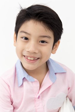 Küçük Asyalı çocuk gri arka yüzünde bir gülümseme ile