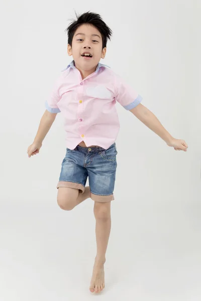 Happy asian boy is jumping at studio. — Stock Photo, Image