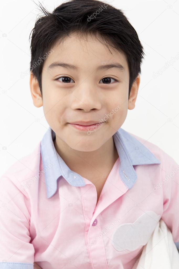 Little asian boy with smile face on gray background