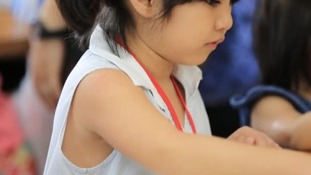 Little Asian girl drawing a picture on the table . — Stock Video