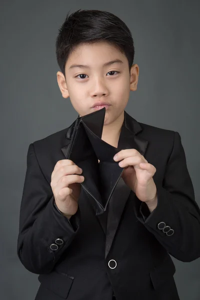 Asijské boy v černém obleku podívat na jeho prázdnou peněženku — Stock fotografie