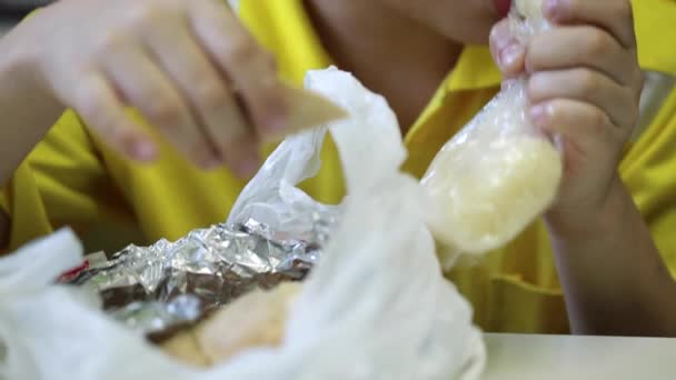 Λίγο Ασίας παιδί απολαμβάνει να τρώει τηγανητό κοτόπουλο με κολλώδες ρύζι — Αρχείο Βίντεο