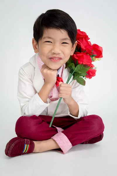 Liten asiatisk pojke i vintage kostym med röd ros — Stockfoto