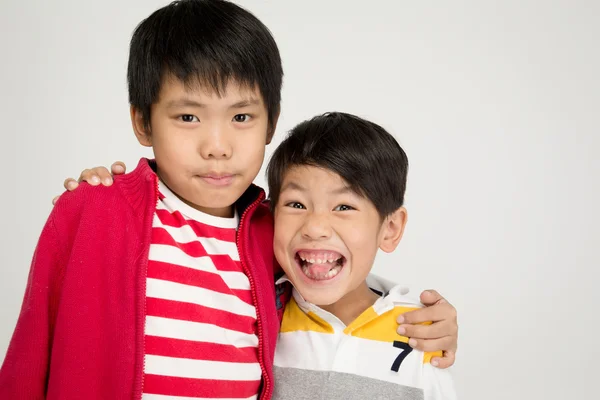 Two happy asian brothers hugging — Stock Photo, Image