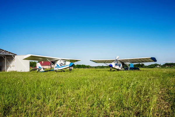 two white light civil aviation aircraft on a moen greenfield