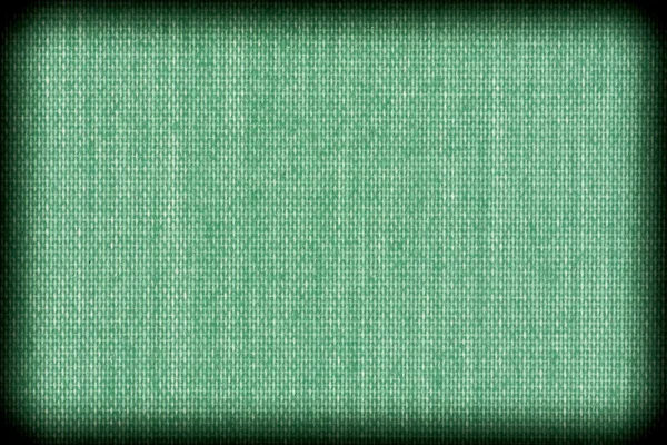 Bakgrundsstruktur av grönt tyg närbild med vinjett — Stockfoto