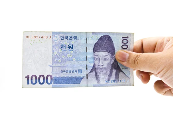 Корейська вона валютних рахунків у руці, ізольовані на білому тлі. — стокове фото