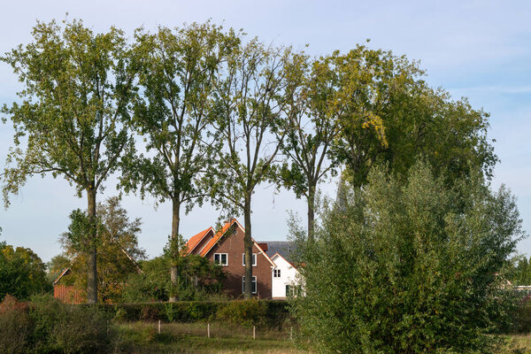 The Traditional Dutch village Ooij protected by a dike to prevent flooding by the river Waal, in Gelderland, Netherlands